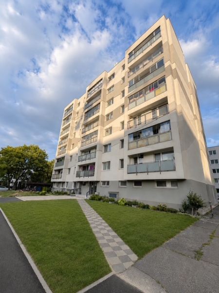 Apartment building on Nobelova Street in Bratislava with a landscaped lawn in front of the building.