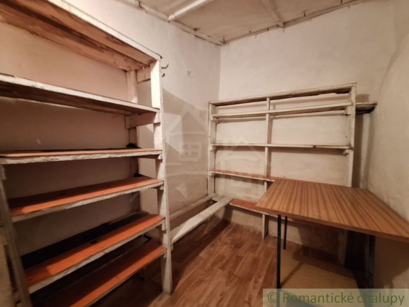A shelf and a table in the interior of a family house, floor with wooden decor.