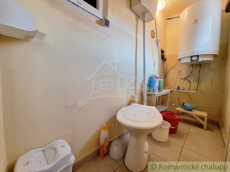 Bathroom with toilet and boiler in a family house.
