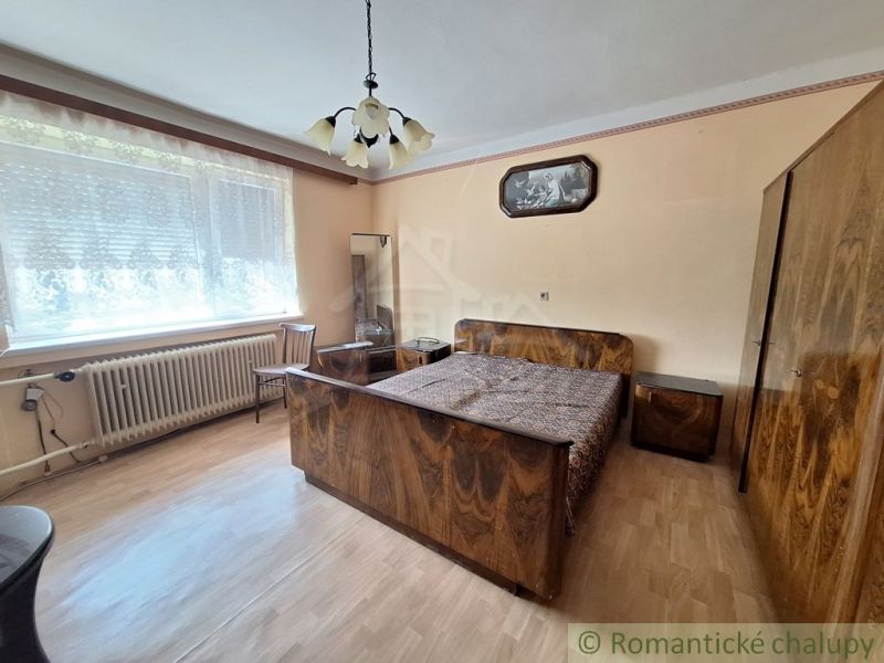 A bedroom in a family house with a wooden decor floor and stylish furniture.