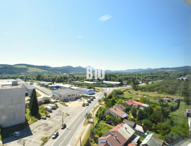 View of the landscape and buildings of Bytča from above, showing the road and buildings.