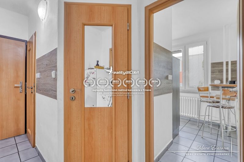 Interior of a 2-room apartment with wooden doors and a glass entrance to the kitchen.