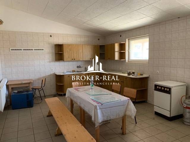 Interior of warehouses and halls with an equipped kitchen, dining table, and chairs.