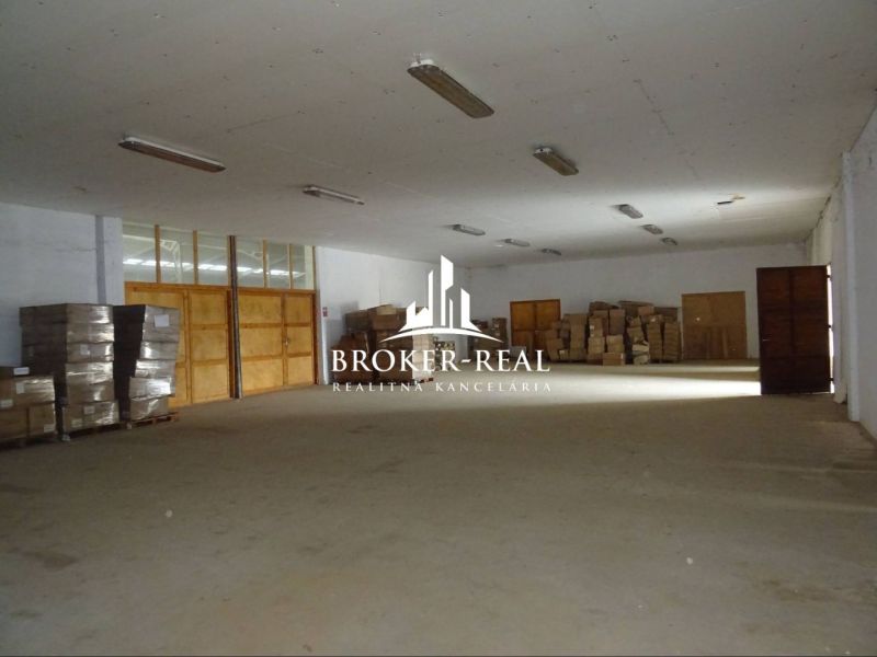 Warehouses and halls with wooden decor flooring and stored pallets and boxes.