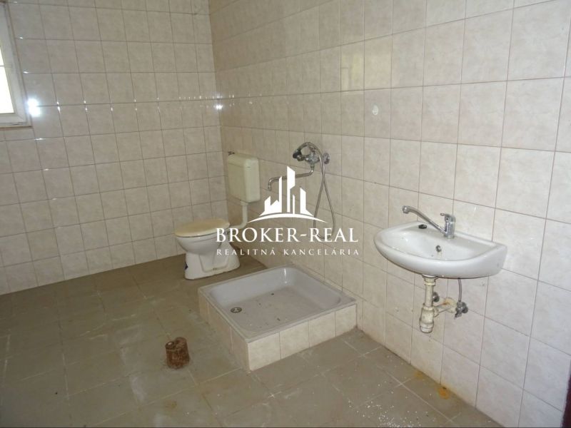 Bathroom in warehouses and halls with tiles, shower, and toilet.