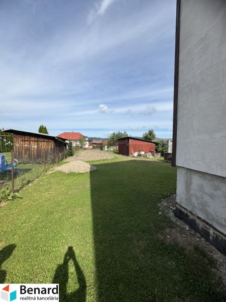 A grassy yard at a family house in Plavnica with a view of further development.