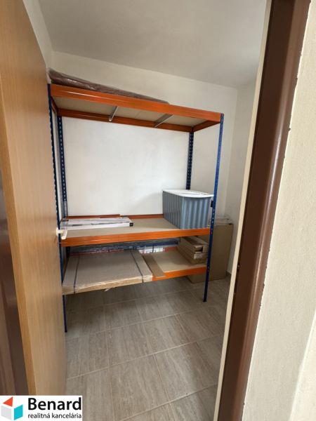 Storage space in a family house with a shelving unit and a floor with a wooden decor.