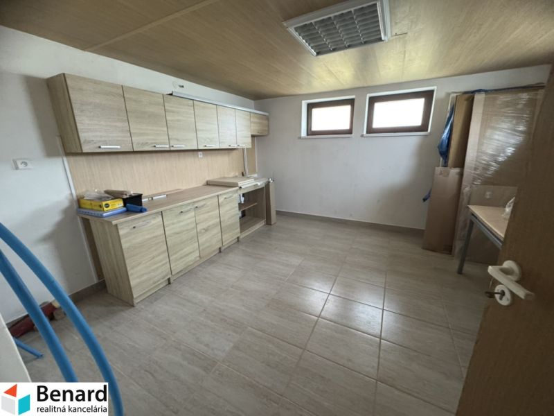 A kitchen in a family house with tiles and a countertop with a wooden decor.