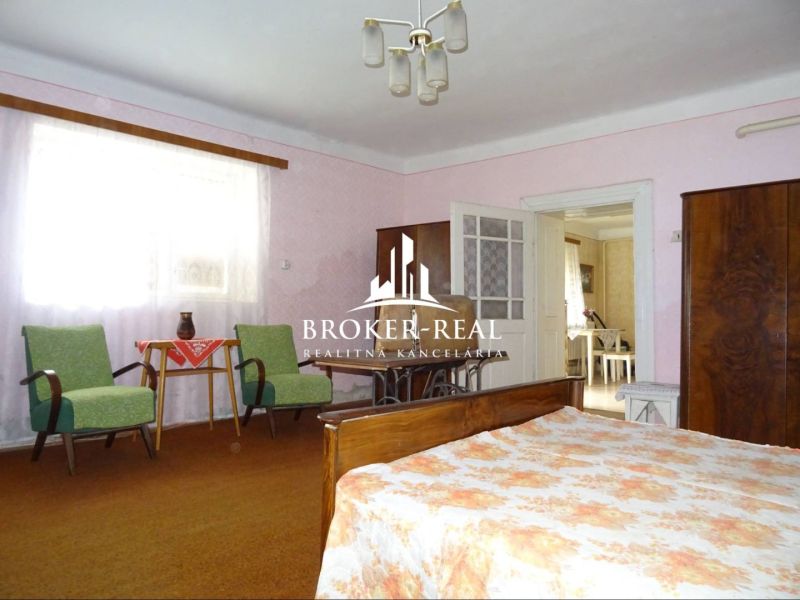 A room in a family house with furniture and a bed, a floor with carpet decor.