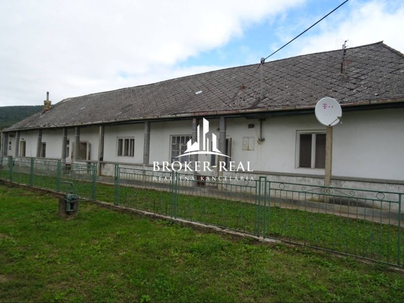 A family house in Černochov, surrounded by greenery, with a satellite dish on the roof.