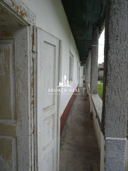 In Černochov, a family house with a long corridor balcony and columns.