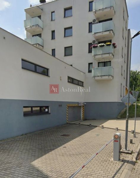 Building with a garage on Švermova Street in Banská Bystrica, parking bollards.