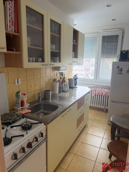 A kitchen in a 2-room apartment with a kitchen unit and appliances.