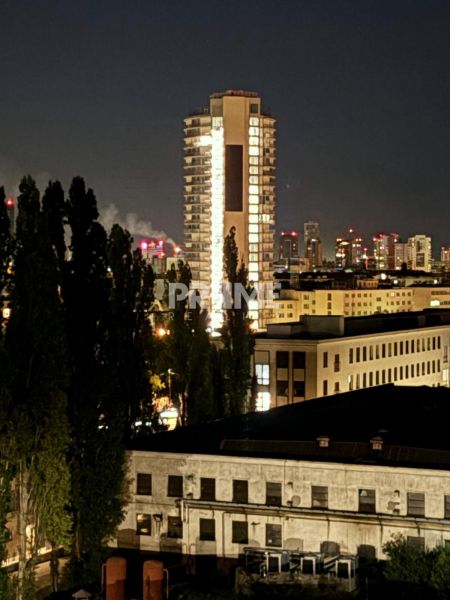 Evening view of an illuminated high-rise building in Bratislava, Nové Mesto on Sliačska Street.