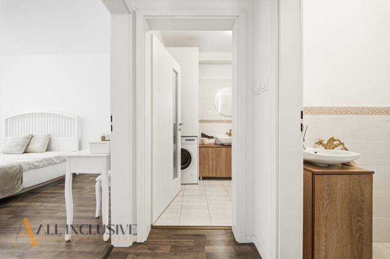 Interior of a 3-room apartment with a wooden decor floor, bathroom, and bedroom.