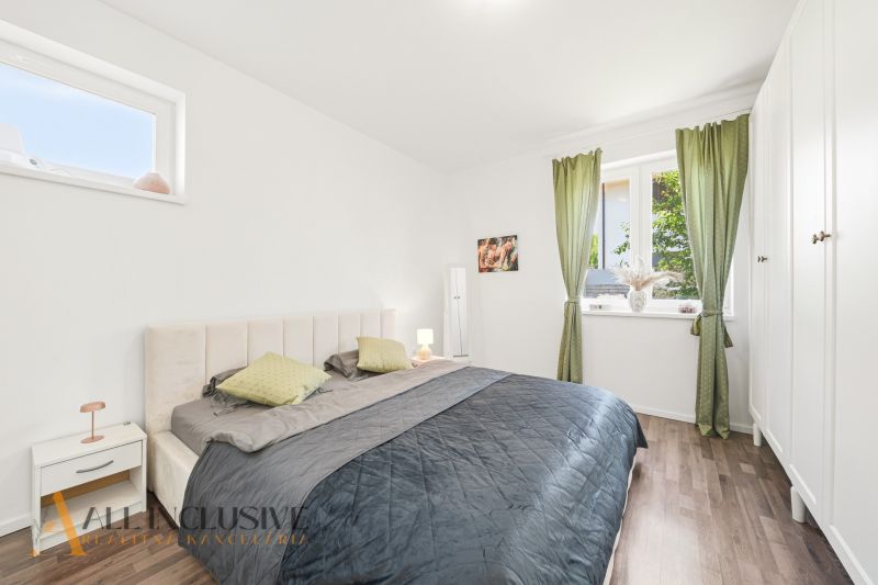 Bedroom with a bed and wardrobes, wooden decor flooring, 3-room apartment.