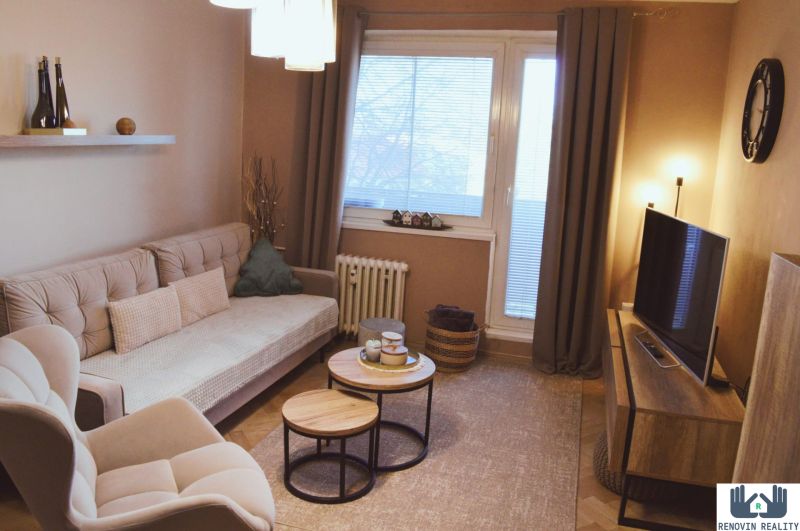 Living room in a 3-room apartment with a comfortable sofa and a floor with a wooden decor.