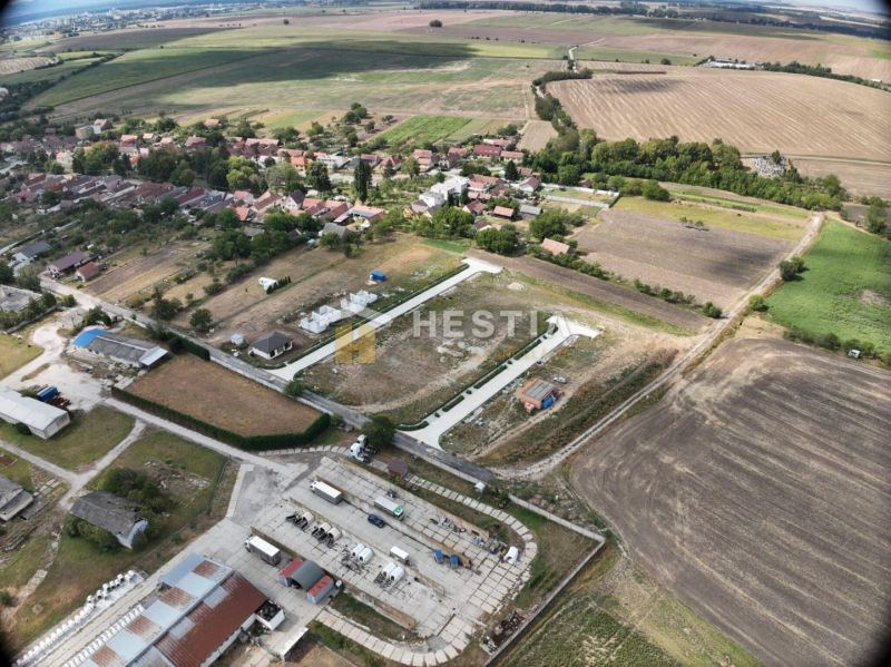 Aerial view of land - housing in Rovensko surrounded by agricultural landscape.