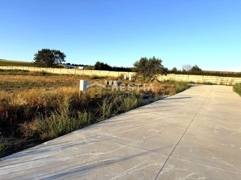 Plots - housing in Rovensko with a concrete area surrounded by nature and fencing.
