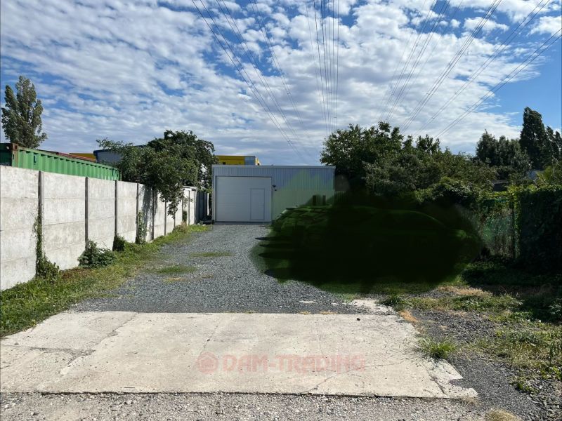 Industrial facility in Záhrady on Galvaniho, Bratislava - Ružinov, surrounded by greenery and concrete walls.