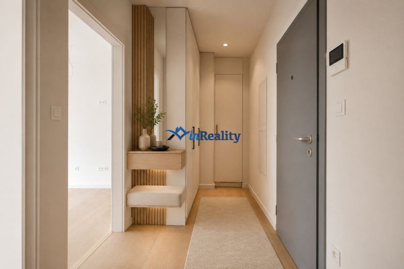 Entrance hall in a 2-room apartment with wood-patterned flooring, light walls, and storage space.