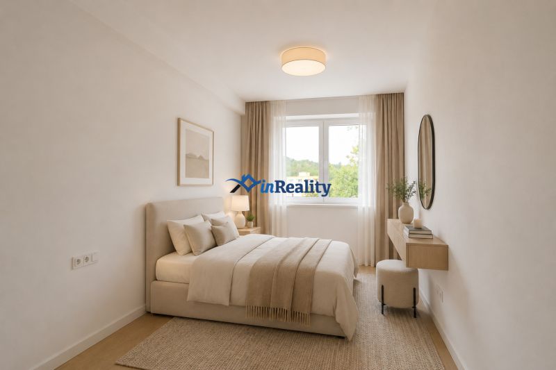 A bright bedroom in a two-room apartment with a wood-patterned floor and simple furniture.