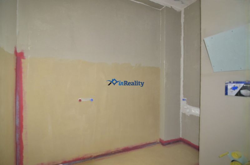 Empty room in a 2-room apartment with basic water and electricity connections.
