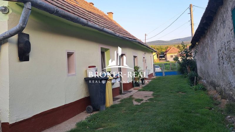 A family house in Gönc with a traditional roof and a landscaped exterior in a quiet street.