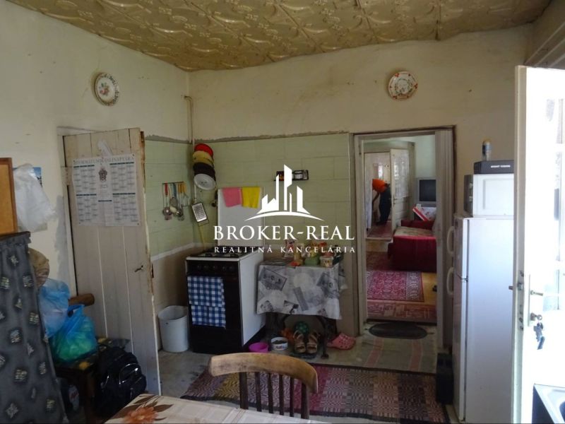 A kitchen in a family house with antique furniture, carpets, and kitchen accessories.