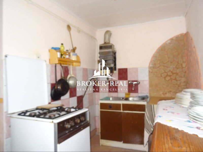 A kitchen in a family house with a gas stove and rustic accessories.