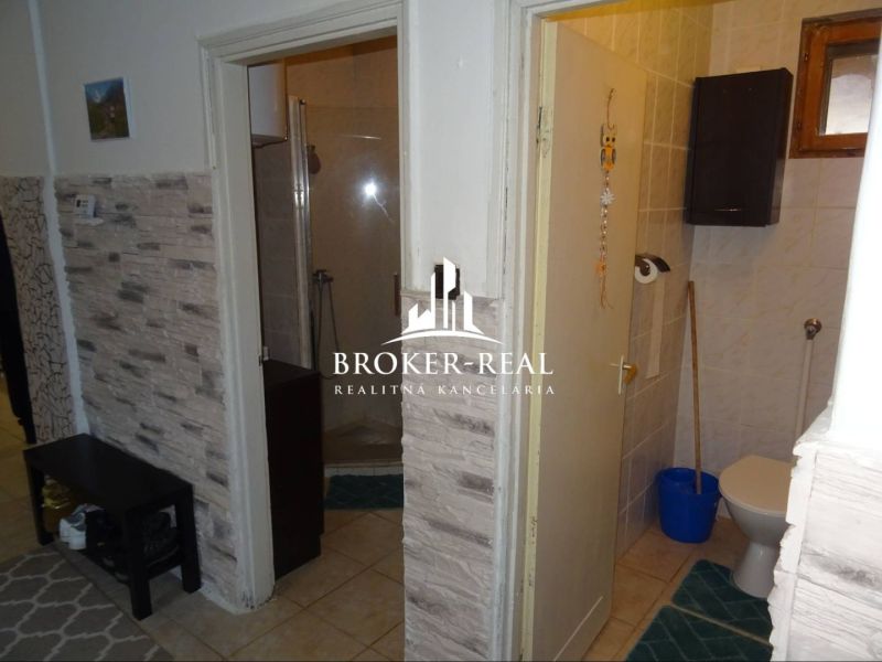 Bathroom with toilet, decorative wall, tiled floor, family house.