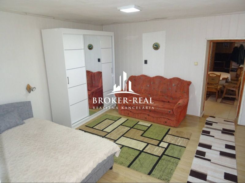 Family house with a bed, sofa, wardrobe, and floor with a wooden decor.