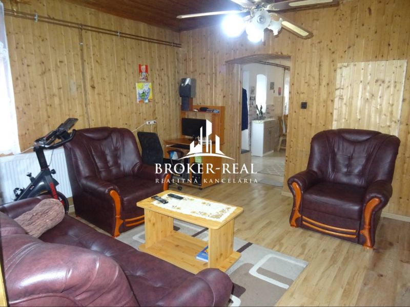 Interior of a family house with leather sofas and a wooden decor floor.