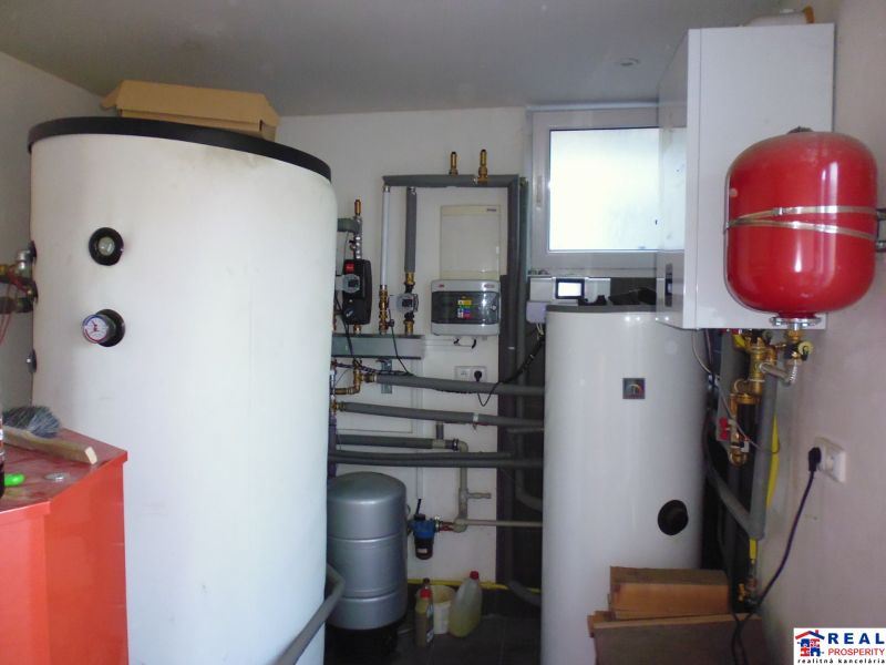 Boilers and tanks in warehouse and hall spaces with piping and accessories.
