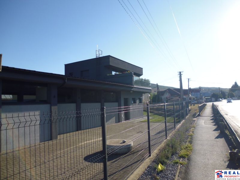 Industrial building in Kračúnovce, warehouses and halls by the main road behind the fence.