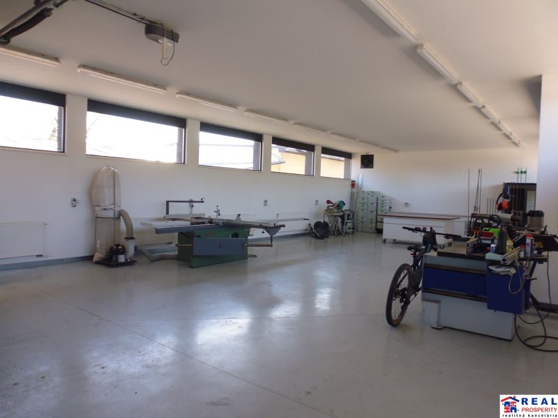 Interior with technical equipment and a bicycle in warehouse and hall spaces.