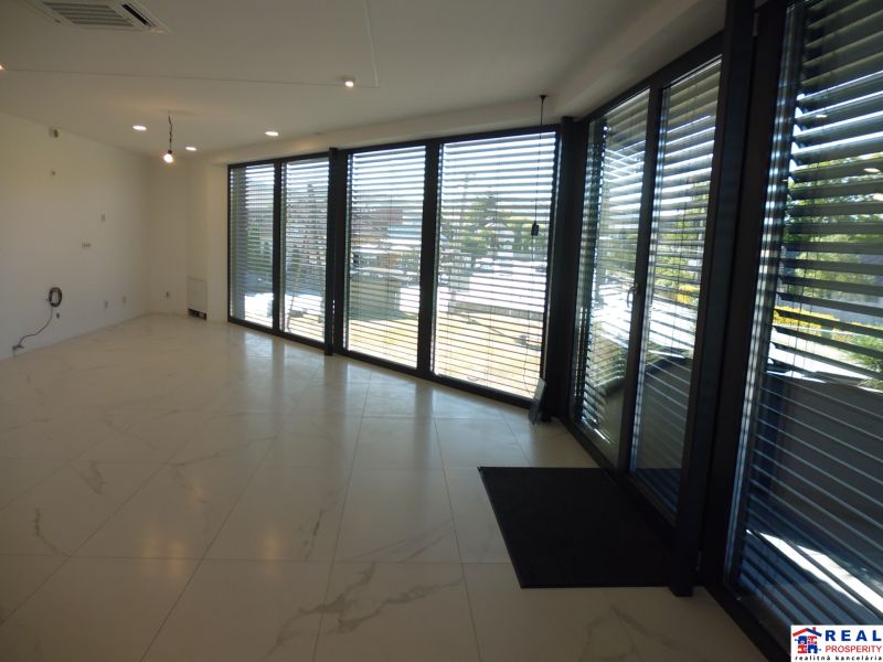 Interior of warehouses and halls with large glass windows and marble-patterned tiles.