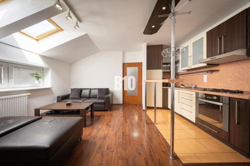 Living room with wood-patterned flooring in a two-room apartment.