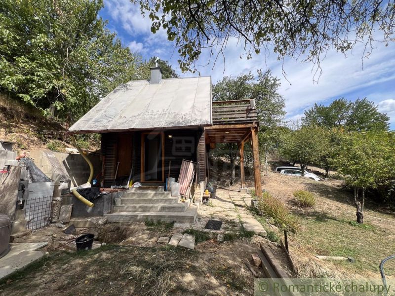 A cottage in Bratislava IV with a wooden shelter in a natural environment.