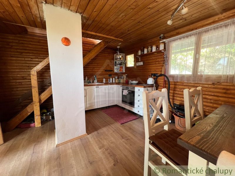 Interior of a cottage with a kitchen and a wooden decor floor.