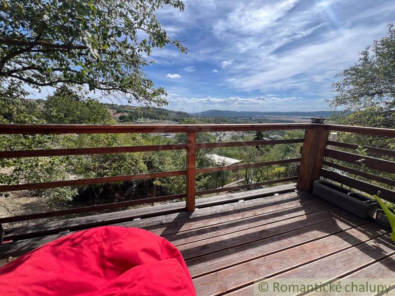 View from the terrace of the cottage in Bratislava IV with comfortable seating and natural surroundings.