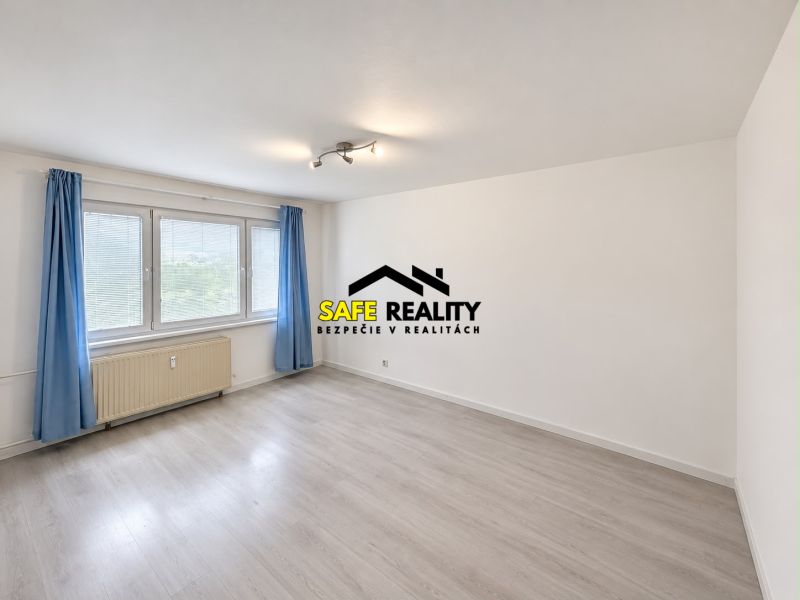 A bright room with blue curtains and a wood-patterned floor in a three-room apartment.