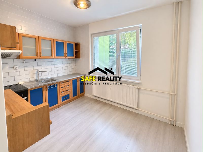 A kitchen in a 3-room apartment with blue cabinets and a wooden decor floor.