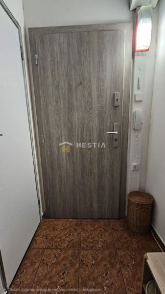 Entrance door with wood decor, next to a basket and tiles.