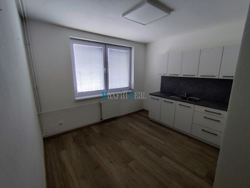 Offices with a kitchenette and flooring with a wood decor.