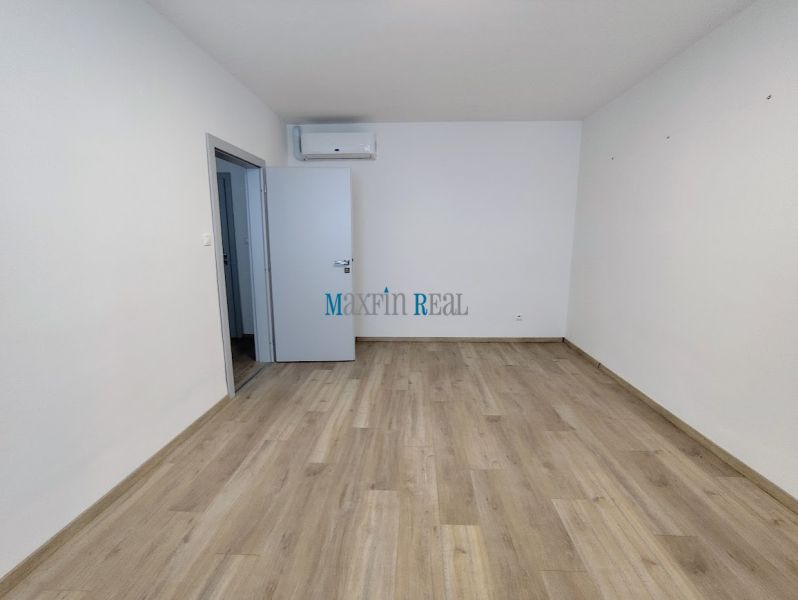 A place with a wooden floor decor, air conditioning, and open doors in Offices.