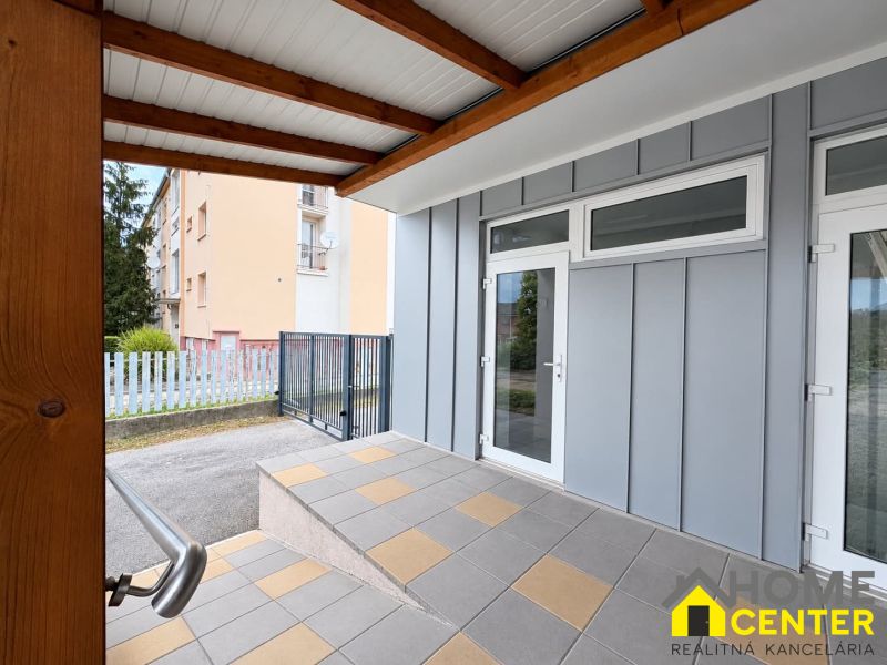 Commercial premises in Komárno with glass entrance doors and a terrace canopy.