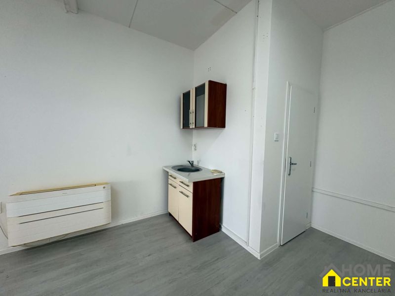 Commercial premises with a kitchenette and a wooden decor floor.