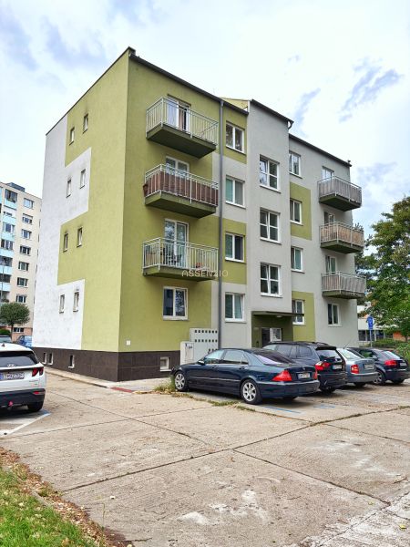 Apartment building with balconies on Andrusovova Street in Bratislava - Petržalka, next to the parking lot.