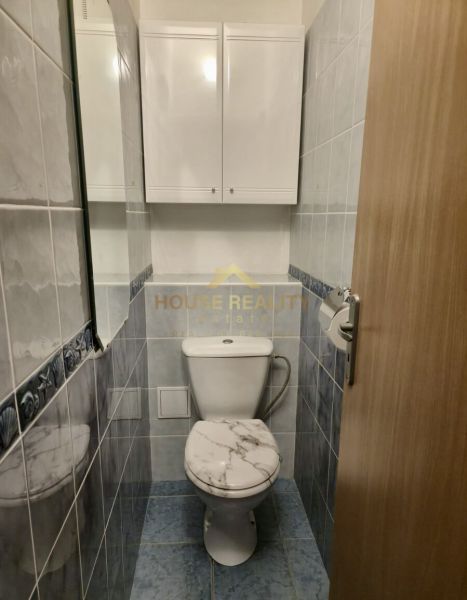 Bathroom with toilet and cabinet in a 3-room apartment.